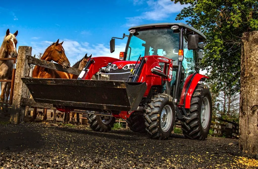 tractor next to a horse pen
